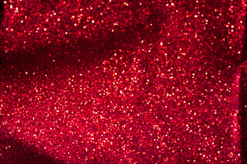 Red glitter bokeh abstract background. Copy space for your design. Selective focus.
