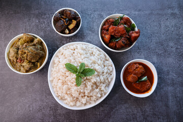 Kerala special food sadhya in banana leaf plate with Chicken fry Duck roast Beef fry Fish curry Cabbage thoran. Festival food for Christmas Easter celebration Kerala India Sri Lanka