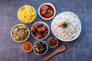 Kerala special food sadhya in banana leaf plate with Chicken fry Duck roast Beef fry Fish curry Cabbage thoran. Festival food for Christmas Easter celebration Kerala India Sri Lanka