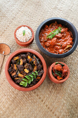 Spicy red beef fry curry and brown rice South Indian dish Kerala, India. side of Ghee rice, Appam, Parotta, Puttu. traditional Christian Muslim feast dish. Buffalo roast, meat pepper fry with coconut.