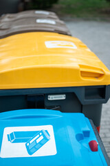Recycling bins for plastic, cardboard and organic in their colors for public use
