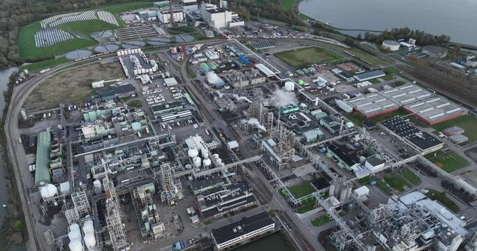 The manufacturing process, materials, sustainability, and innovation in a factory specializing in synthetic polymers and plastics. Birds eye aerial drone view. Dordrecht, The Netherlands.