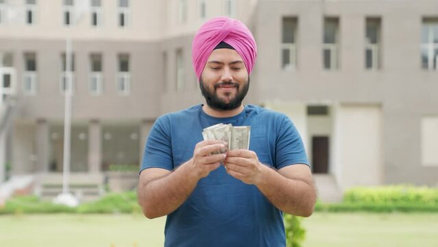 Sikh Indian Man Counting Money, 500 Indian Rupees