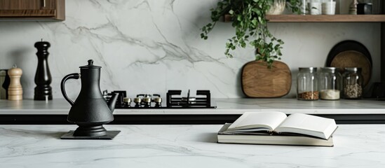 A book on a white marble counter near a black burner.
