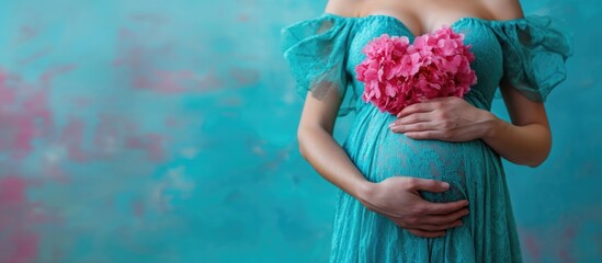 Pregnant lady in blue dress embraces pink heart.