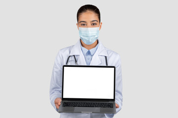 Professional european doctor in a white lab coat and protective face mask