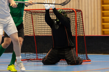Floorball players competing against each other in a floorball championship game