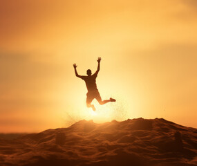 Person leaps joyfully on a beach, dirt and gravel suspended in the air around them.