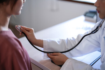 Asian psychologist women using stethoscope to check up patient and giving counseling about medicine and mental health therapy while female patient stress and anxiety with psychological health problem