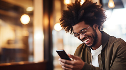 An young man with huge afro looking at the smartphone and laughing closeup. - obrazy, fototapety, plakaty