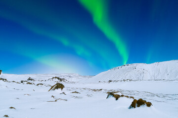 Aurora Borealis. Northern Lights over the mountains. Scandinavia. Winter night landscape with...