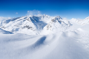 Winter mountain landscape. Wallpaper or background. Cold weather and frost. A place for skiing. Ski...