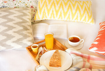 Cozy breakfast in bed with tea
