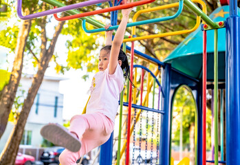 Happy child girl  playing at outdoor playground in the park on , outdoor or playground