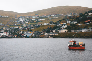 Fototapeta premium boats on the fjord near a nordic village
