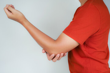 Health concept, person with elbow pain, man holding hand on elbow with pain, bone arthritis
