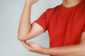 Health concept, person with elbow pain, man holding hand on elbow with pain, bone arthritis