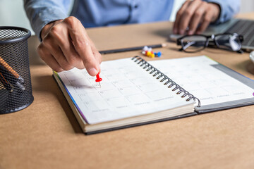 Businessman agenda calendar and reminder agenda work online at home men plan daily appointments and vacation travel journals in a diary at their desk . calendar reminder event concept .