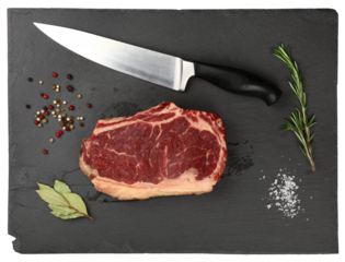 Close up raw beef ribeye steak on slate board