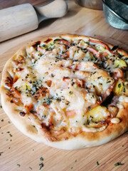 Delicious pizza with mozzarella on a wooden board.