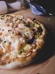 Delicious pizza with mozzarella on a wooden board.