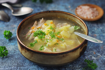 A bowl with chicken soup with pasta