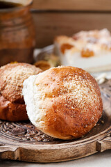 Sweet homemade buns on rustic wooden table. Delicious breakfast.