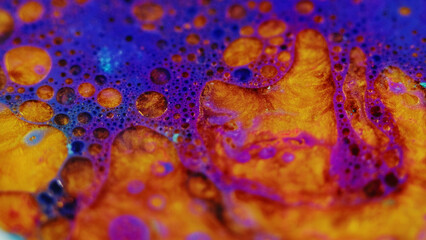 Bubble fluid. Foam texture. Defocused blue purple golden color glitter oil paint blend wave flow...
