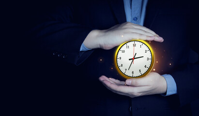 Businessman showing a watch Gold color on black background with copy space. concept of time management and counting time