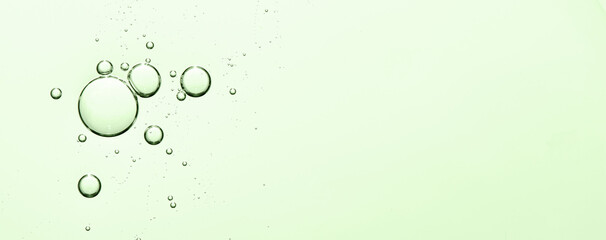 Green texture of cosmetic serum with bubbles. Copy space.