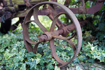 Close-up photo of an old and rusty wheel from an agricultural machine.