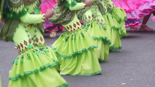 During the annual celebration of the coconut festival, street dancers in various local and native costumes perform in a frenzy along the street to pay homage to a Patron Saint.