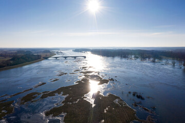Floods - Aerial view over large flood area with sun reflection, Land under water in inland Germany and Poland, Europe