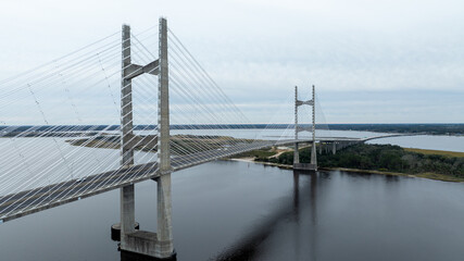 The Dames Point Bridge in Jacksonville, Florida, captured in daylight with cars driving over and water underneath.