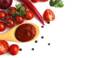 A wooden spoon with tomato sauce and vegetables lies on a white background.