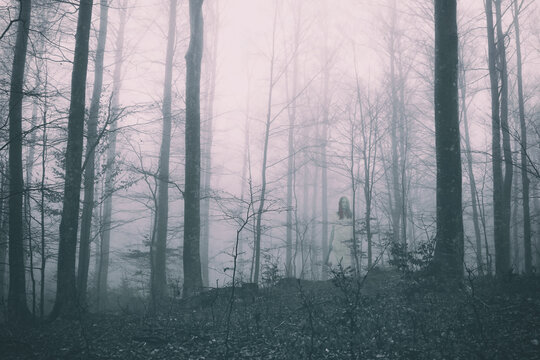 Horror scene of a scary woman in deep dark forest.