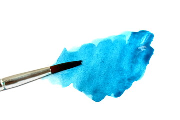 On a white background there is a blot of blue paint with a brush.