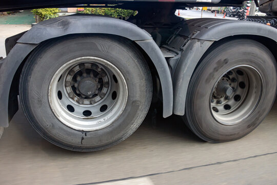 View of the rear wheels of a truck while driving with the rear axle raised