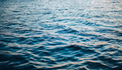 Fototapeta premium Crystal-clear water surface reflecting vibrant blue sky, symbolizing purity, tranquility, and serenity. Ideal for concepts of clarity and calmness