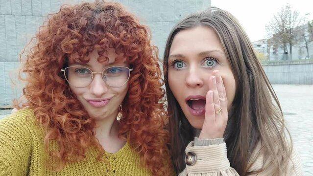 Friends pulling faces while taking a funny selfie outdoors