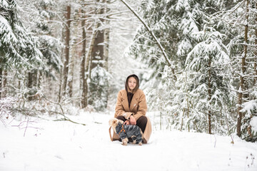 Portrait of a young beautiful girl in a winter forest.