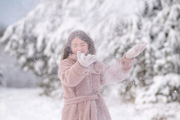 Portrait of a young beautiful girl in a winter forest.