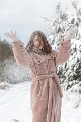 Portrait of a young beautiful girl in a winter forest.