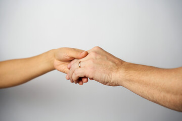 Close-up man and woman hands with wedding ring