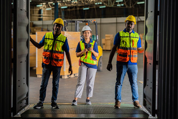 A group of African American workers checking the goods in the container. Factory workers are keeping inventory records in the warehouse. industrial concept work at the warehouse