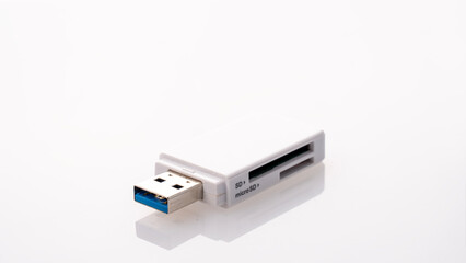 Flash card reader on white background Close-up, adapter SD to USB, microSD to USB