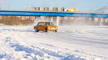 Auto racing and drifting on ice in retro car, Car at high speed moves on slippery road, icy road, Drift car on ice, Auto ice racing, Tinted, Selective Focus, Sun Flare