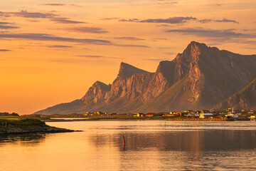 Evening view over northern Lofoten, Norway. Mountains, sea, reflections, cloudscape. Spectacular scenery. The town of Ramberg in the distance.