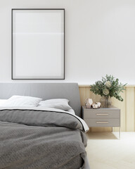 Minimalist bedroom showcasing a comfortable bed with grey bedding, a sleek bedside table with lamp, and a large blank framed art piece on the wall. 3D render