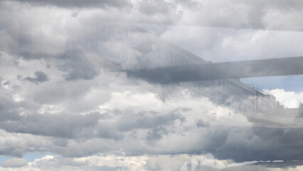 Fototapeta na wymiar Reflection of the building and clouds